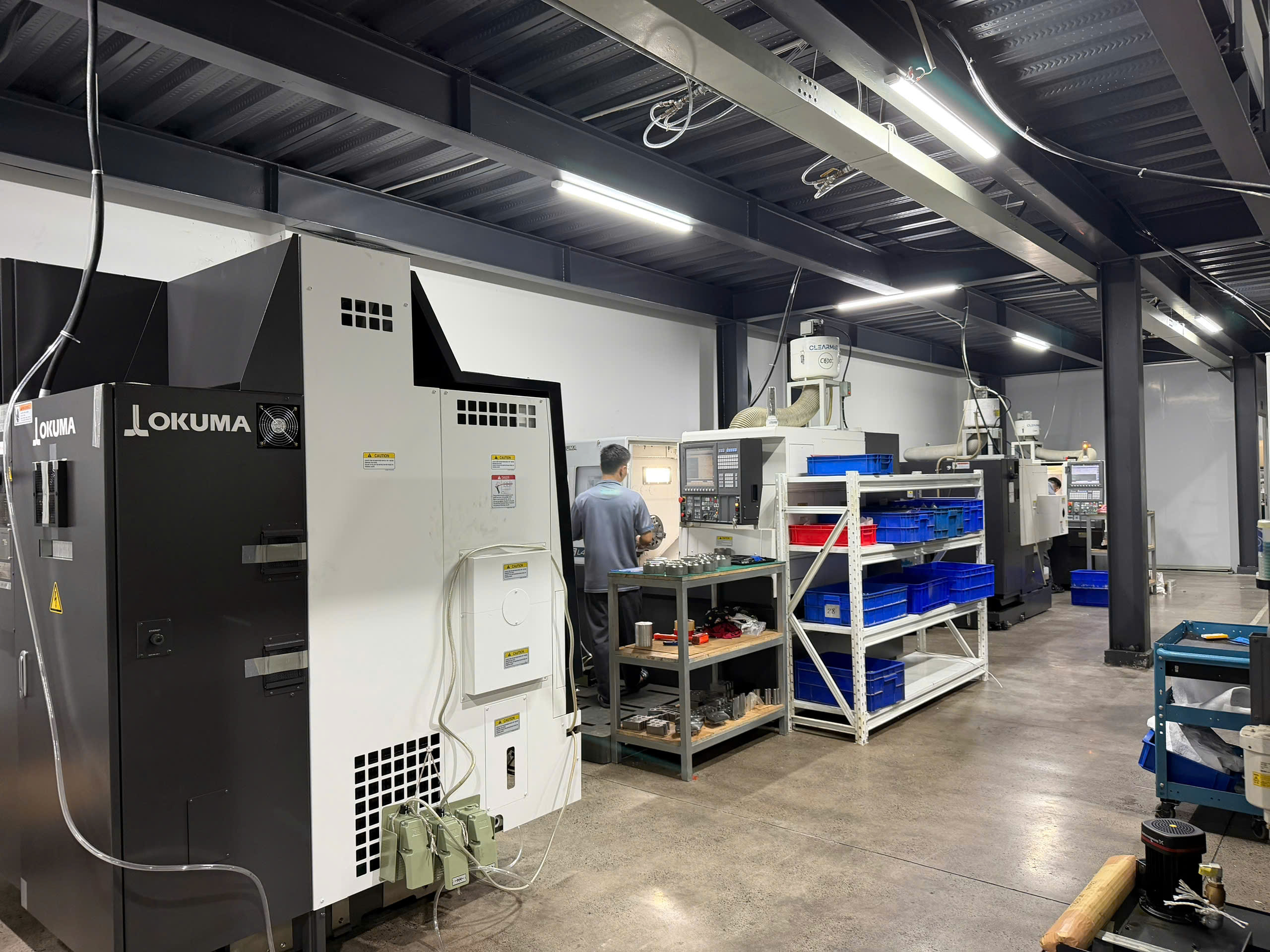 Row of Okuma CNC lathes on the shop floor